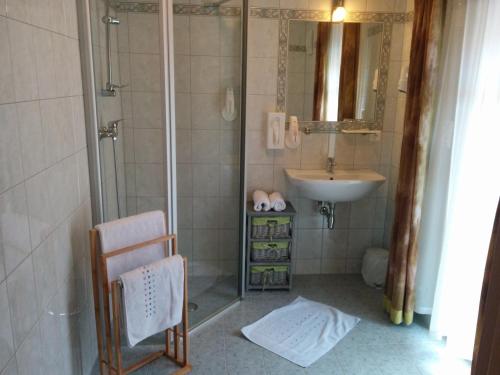 a bathroom with a shower and a sink at Rebenlandhof in Leutschach