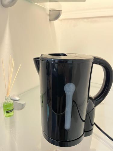 a black coffee pot sitting on a counter at B&B Due Su Due Holiday in Vietri sul Mare