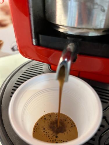 a coffee being poured into a white bowl at B&B Due Su Due Holiday in Vietri sul Mare