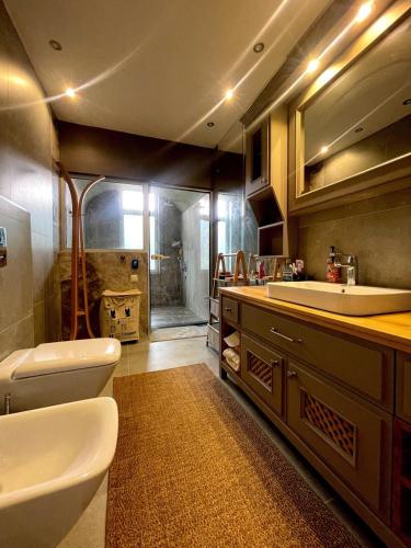 La salle de bains est pourvue d'un lavabo, de toilettes et d'une baignoire. dans l'établissement Antalya Holiday Villa, à Dosemealti