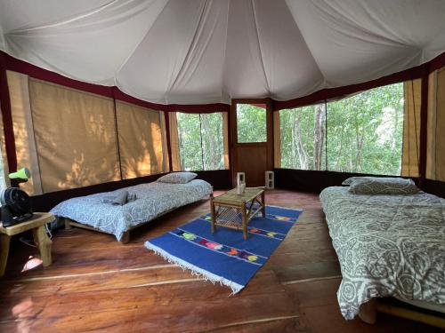 a bedroom with two beds in a tent at Magical jungle Eco Cabana -Tulum in Macario Gomez