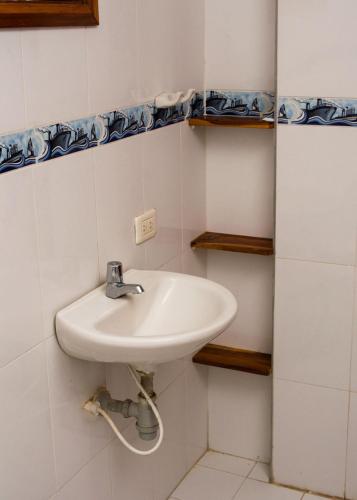 a bathroom with a white sink in a room at HOSTAL LA BOQUILLA in Cartagena de Indias