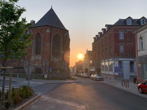 an empty street with a church with the sunset in the background at 45 Grande Rue bis in Ault