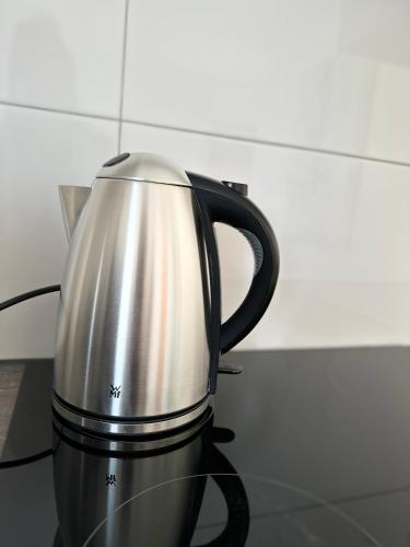a silver tea kettle sitting on a counter at Dream Apartments in Hohenems