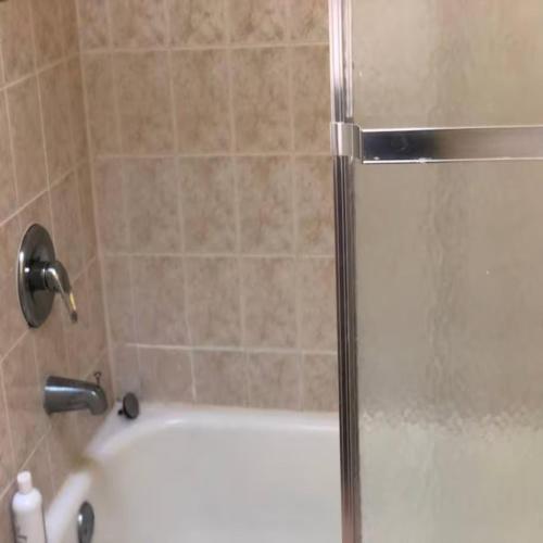 a bathroom with a shower with a bath tub at Business & Family Friendly Balcony Jacuzzi Free Park in Jersey City
