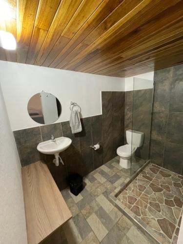 a bathroom with a sink and a toilet at Ancestral Casa de Campo in Roldanillo