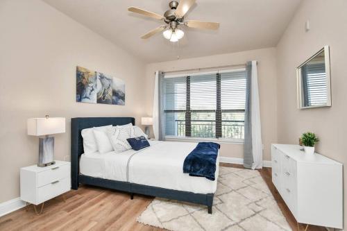 a bedroom with a bed and a ceiling fan at Ultimate Retreat Near GALLERIA-POOL in Houston