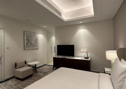 a hotel room with a bed and a flat screen tv at MH- Spectacular Villa in Address Beach Resort Fujairah in Fujairah