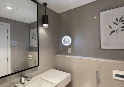 a bathroom with a sink and a mirror at MH- Spectacular Villa in Address Beach Resort Fujairah in Fujairah