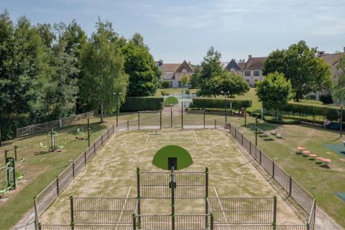 an empty playground in a park with trees at Marriott's Village d'Ile-de-France in Bailly-Romainvilliers