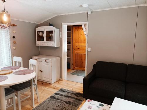 a living room with a couch and a table at Ljungdahl in Korppoo