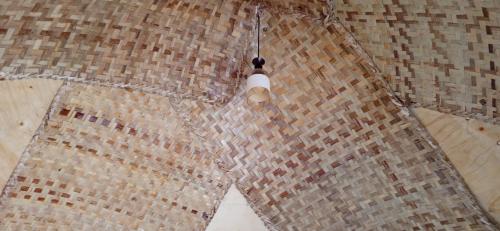 a ceiling with a light in a room at Plastic Bottles House in Entebbe
