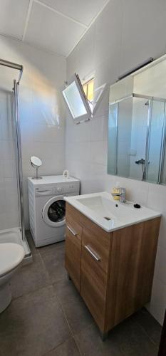 a bathroom with a sink and a washing machine at Nice studio with pool and internet fiber in Torremolinos