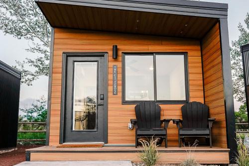 two chairs sitting on the porch of a tiny house at Casitas at Capitol Reef in Torrey