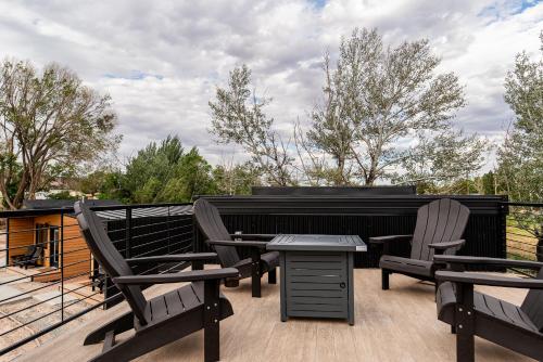a patio with two chairs and a table on a deck at Casitas at Capitol Reef in Torrey