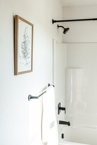 a bathroom with a towel rack and a mirror at Casitas at Capitol Reef in Torrey