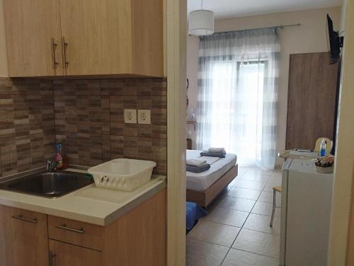 A kitchen or kitchenette at La MER Rooms Peraia