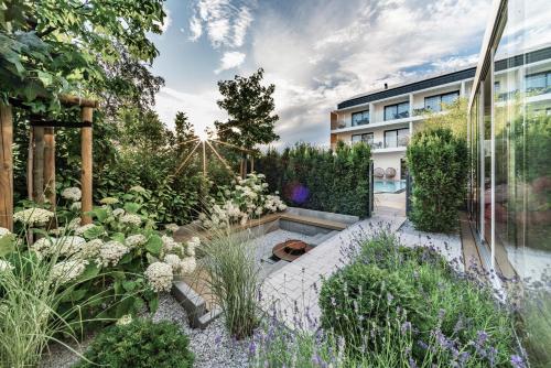 a garden with a pool and a building at Rosa Style in Rowy