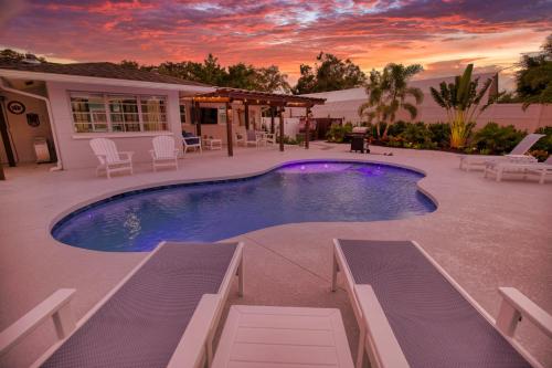 a swimming pool in front of a house at Tropical Oasis, Heated Pool, Hot Tub, Near Siesta Key in Sarasota