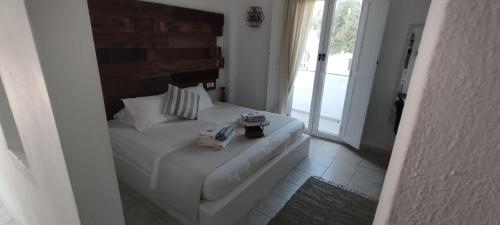 a bedroom with a bed with two cameras on it at Ammos Luxury Studios in Aliki