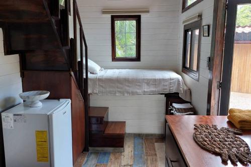 a tiny house with a bedroom and a bed at Tiny House Villa... in Santa Cruz