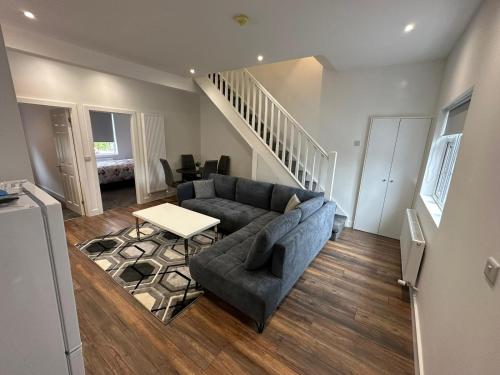 a living room with a couch and a staircase at Modern design residence in Dublin