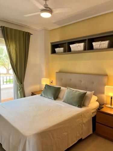 a bedroom with a large white bed with two pillows at Casa Calida in Sucina