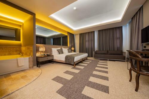 a hotel room with a bed and a couch at Four Mansions Hotel in Kayseri