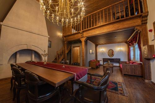 a living room with a table and a chandelier at Four Mansions Hotel in Kayseri