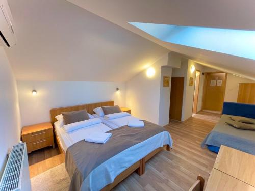 a bedroom with a large bed and a desk at Hotel Keltika in Izola