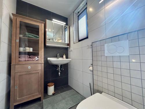 a bathroom with a toilet and a sink at Villa Pauline - FeWo “Provence“ in Bad Sooden-Allendorf