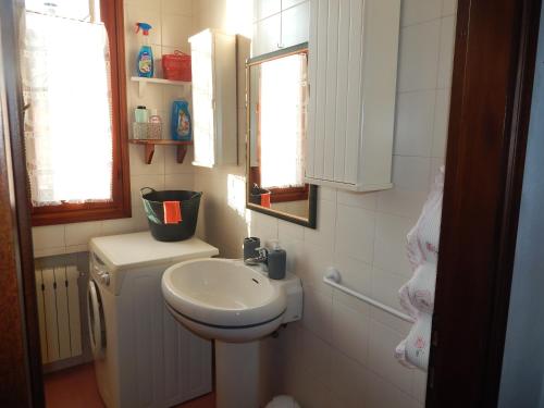 a small bathroom with a sink and a toilet at Ada home in Venice