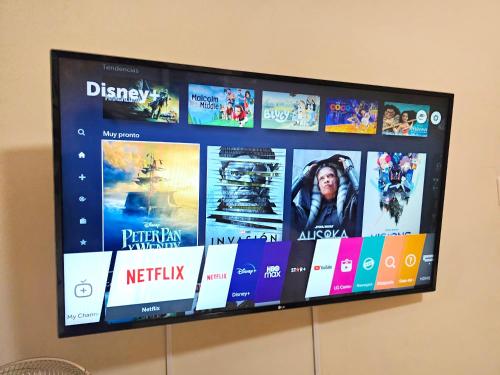 a flat screen tv hanging on a wall at Hospedaje Celerina & Elio in Lima