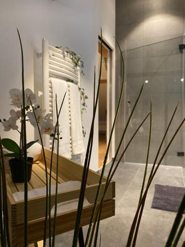 a bedroom with a bed and a mirror and plants at Eine schöne Wohnung an der Birs in Basel