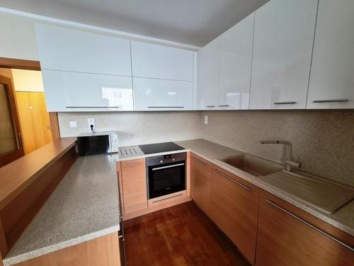 a kitchen with white cabinets and a sink at Apartment 'ACTIVE LIFE' - near to Hockey, Football and Basketball stadium, VIVO Shopping center in Bratislava
