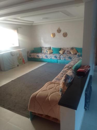 a room with two beds and a couch in it at Villa en location in El Jadida