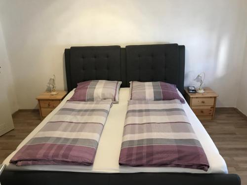 a bed with two pillows on it in a bedroom at Lindenberger Ferientraum in Lindenberg im Allgäu