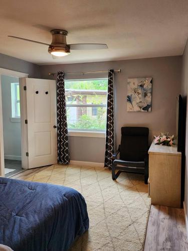 a bedroom with a bed and a window and a chair at Cozy Bedroom with Private Ensuite Bathroom - Room # 2 in SAHRED house NO PET in Orlando