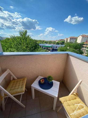 a balcony with a table and chairs and a view at D Apartment Free private Parking in Novi Sad