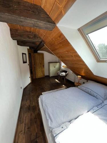 a bedroom with a bed and a wooden ceiling at Hamerská chaloupka in Hlinsko