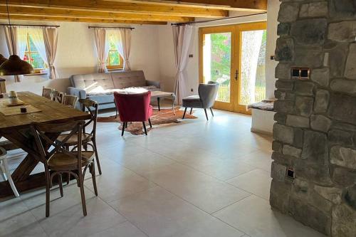 a living room with a table and a stone wall at Hamerská chaloupka in Hlinsko