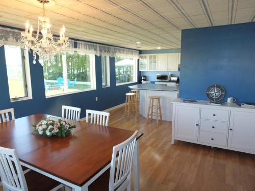 a kitchen and dining room with a table and chairs at The Life Aquatic - Lakefront Kayaks Included! in Alpena
