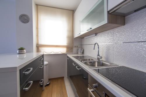 a small kitchen with a sink and a window at Apartments Villa Novak 1 in Okrug Donji