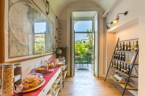 a room with a table with food and wine bottles at The Bellini House by House In Naples in Naples