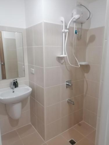 a bathroom with a shower and a sink at Roxas Blvd Stunning Studio Condo Near US Embassy in Manila