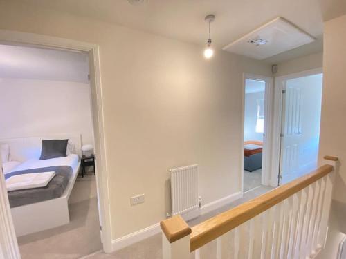 a bedroom with a bed and a large mirror at Brand New Stylish 3 Bed House in Milton Keynes