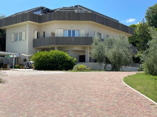 a house with a brick driveway in front of it at Locanda Belvedere in Saludecio
