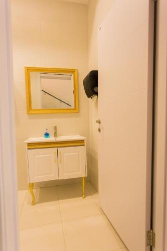 a bathroom with a sink and a mirror at Kumasi Luxury Apartments @ The Fairview in Kumasi