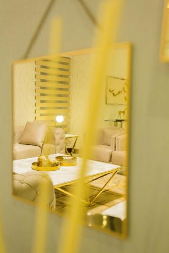 a living room with a couch and a table in a mirror at Kumasi Luxury Apartments @ The Fairview in Kumasi