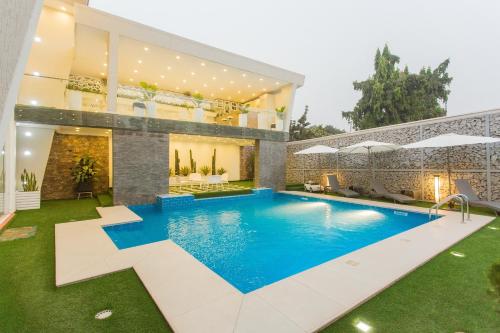 a swimming pool in the backyard of a house at Kumasi Luxury Apartments @ The Fairview in Kumasi